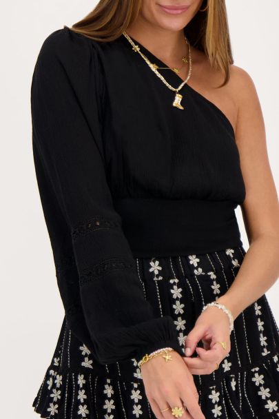 Black one-shoulder top with smock and tapes