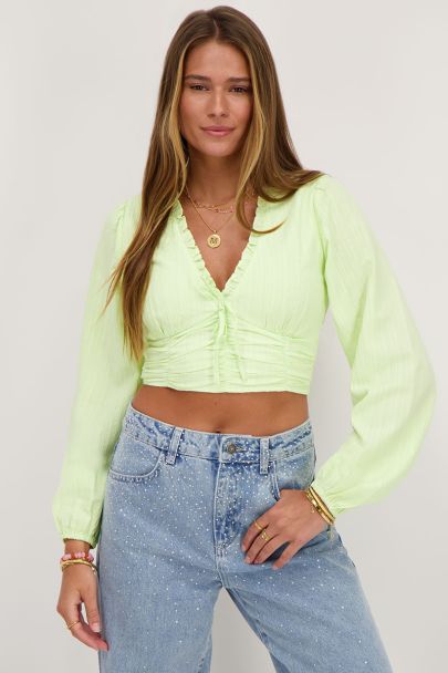Green crop top with ruffles and smock