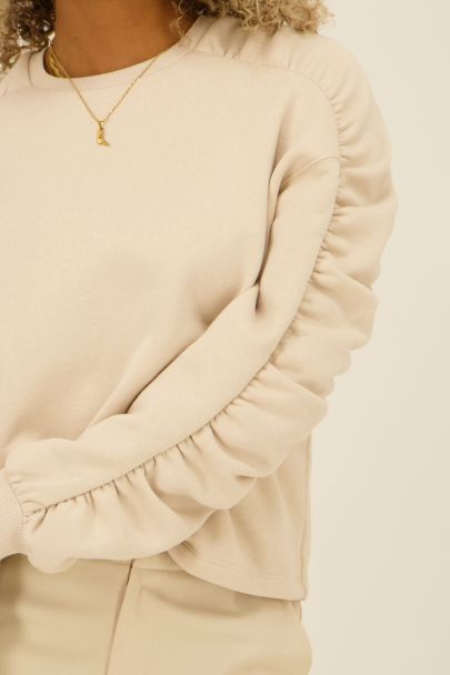Beige sweater with ruffled sleeves