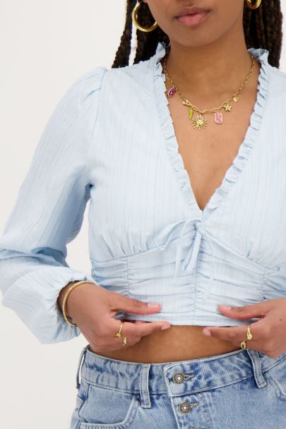 Light blue crop top with ruffles and smock