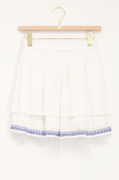 White skirt with blue embroidery border