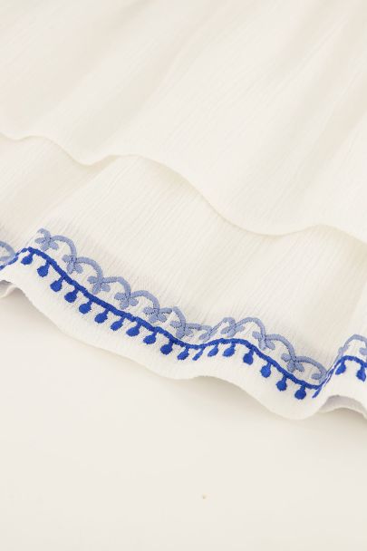 White skirt with blue embroidery border
